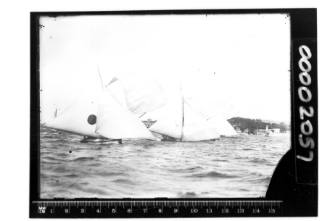 Three 18-footers on Sydney Harbour, the boat with a two-tone ball insignia is ROSETTA.