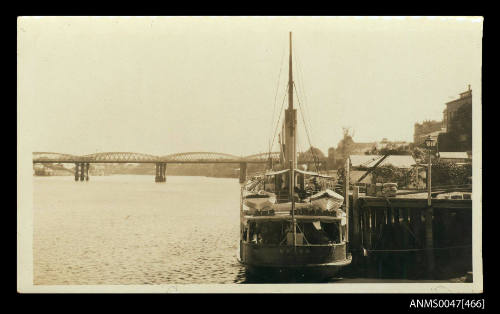 SS OTTER, 242 tonnes, loading unloading cargo at a small wharf in Brisbane