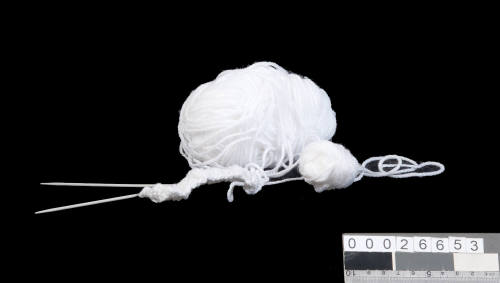 Knitting needles and wool kept in storage box made from Christmas cards