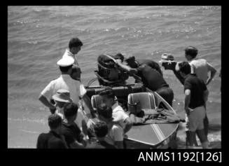 Black and white negative number 27A depicting several people inspecting the interior of power boat LITTLE HUNTER , Jctwo7n