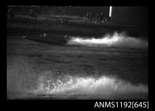 Black and white negative number 27A depicting view of QUICK-CAT with twin Chrysler outboard engines, at speed, port side view