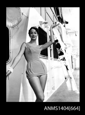 Photographic negative of a swimsuit model posing on a ship