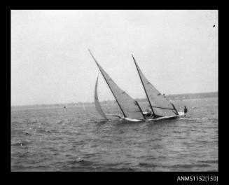 The port side of twin masted sailing canoe at speed