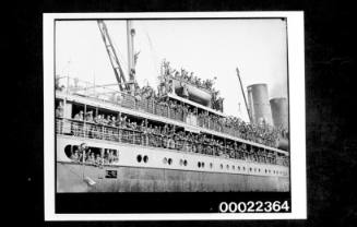Passenger liner with solders crowding on three decks