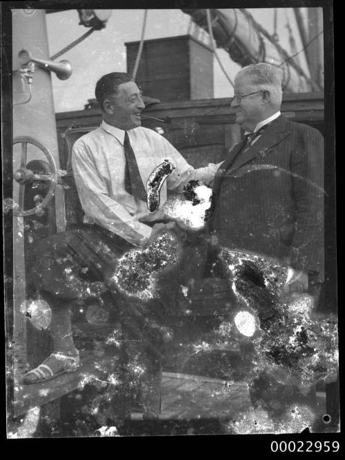 Count Felix Graf von Luckner shaking hands with an unidentified man on board SEETEUFEL