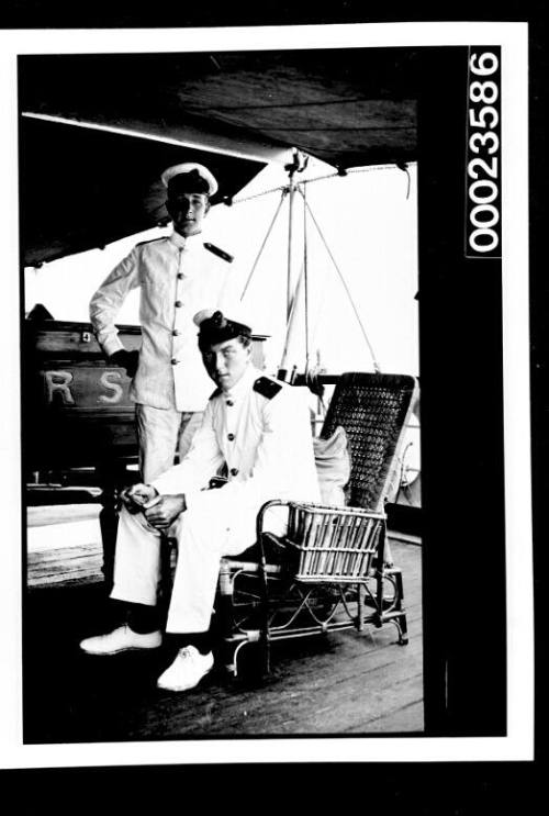 Ships and steamer crews, two men officers on deck, one holding a letter