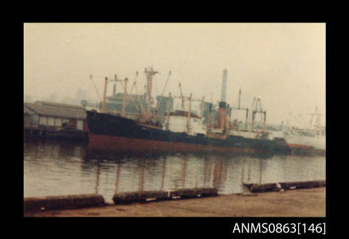 A cargo ship possibly departing from a wharf