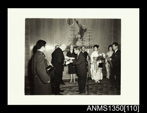Captain Dun being presented with a gift