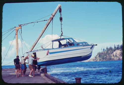 Fishing boat being lowered into the water