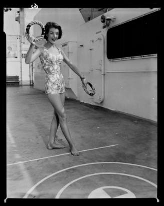 Photographic negative of a swimsuit model posing on a ship with quoits