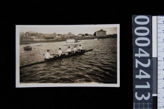 YWCA Women's rowing team with male coxswain