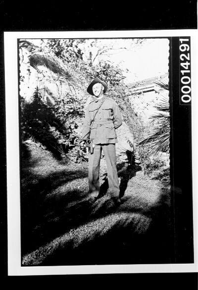 An Australian soldier in uniform in a garden