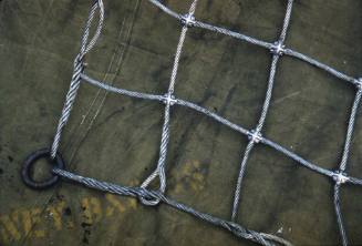 Slide close up of the corner of a metal wire cargo net