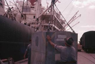 Slide of metal pallet bein loaded onto cargo vessel