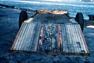 Slide depicting a metal flat bed trailer with ramp