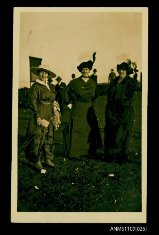 Photographic postcard of three women possibly at the races